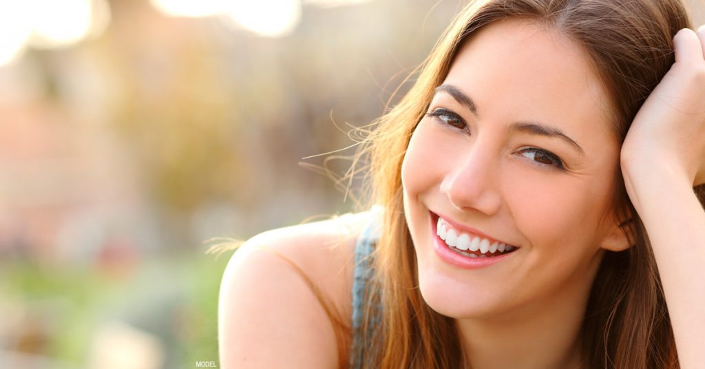 Woman smiling after rhinoplasty