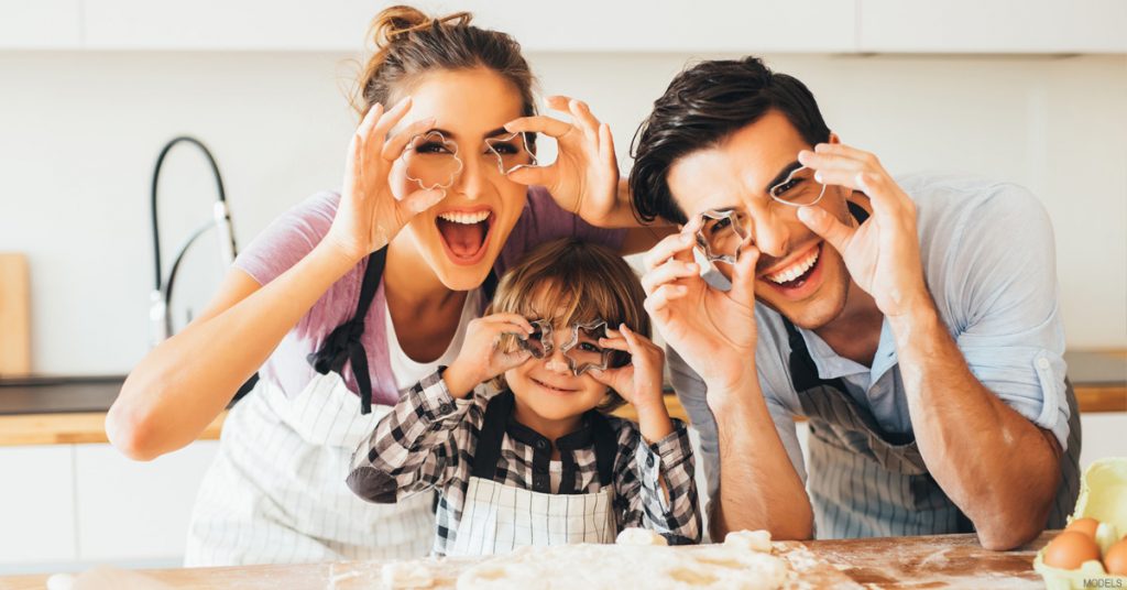 Family With Unique Noses Holding Cookie Cutters