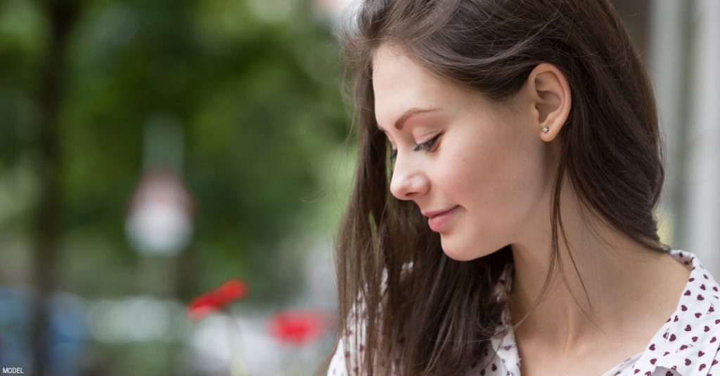 Woman showing off her nose from an angle.