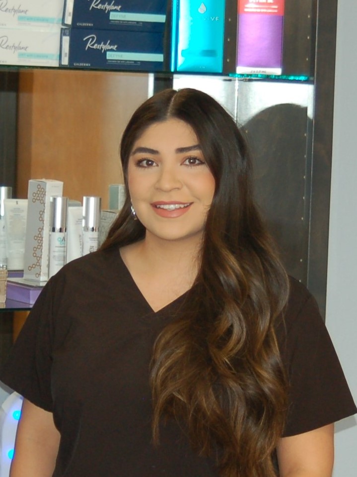 Alexandra Ochoa in scrubs in front of skincare product shelf at Foothills Facial Plastic Surgery