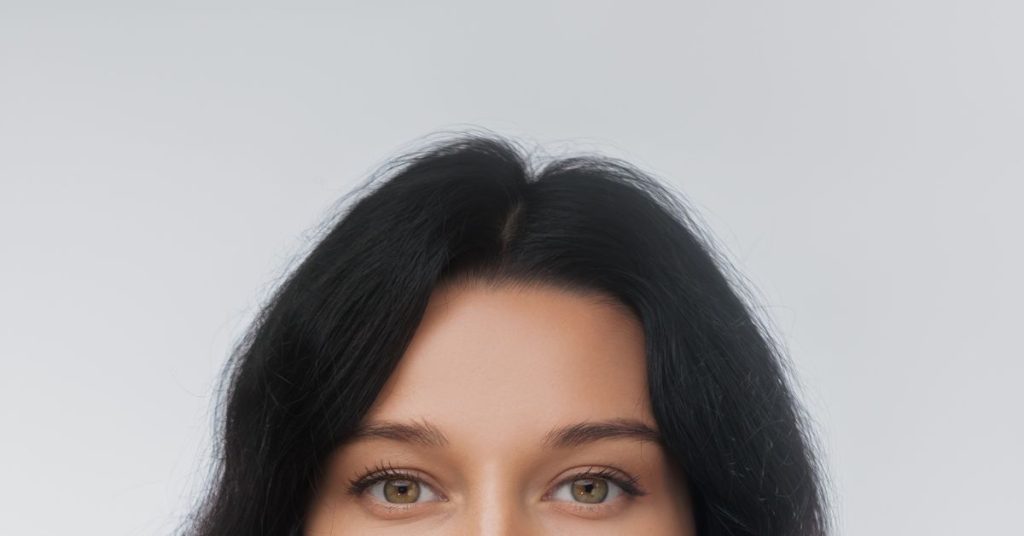 A woman's face from the nose up, highlighting her forehead. (Model)