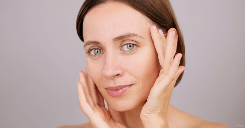 Woman touching her face (model)