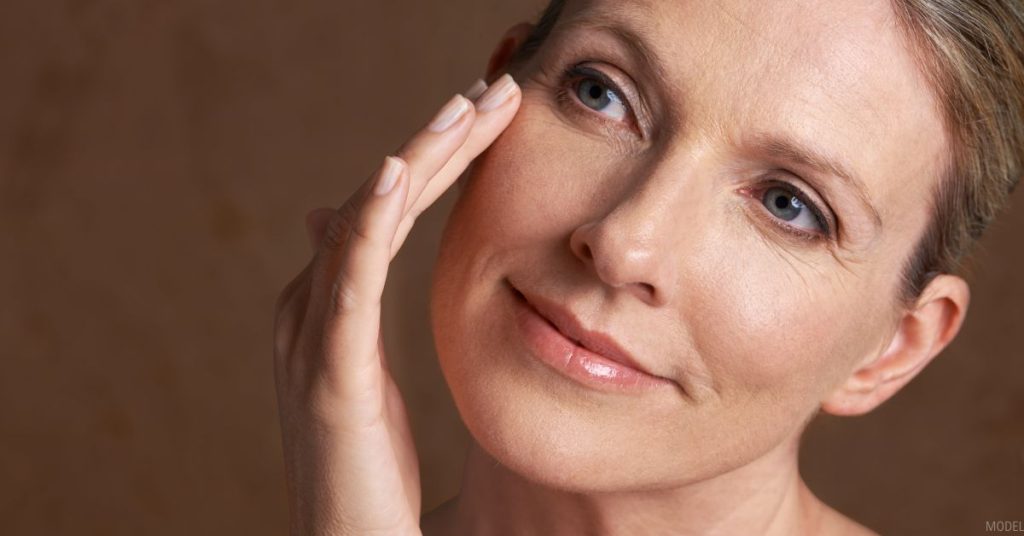 Woman touching under eye area (model)